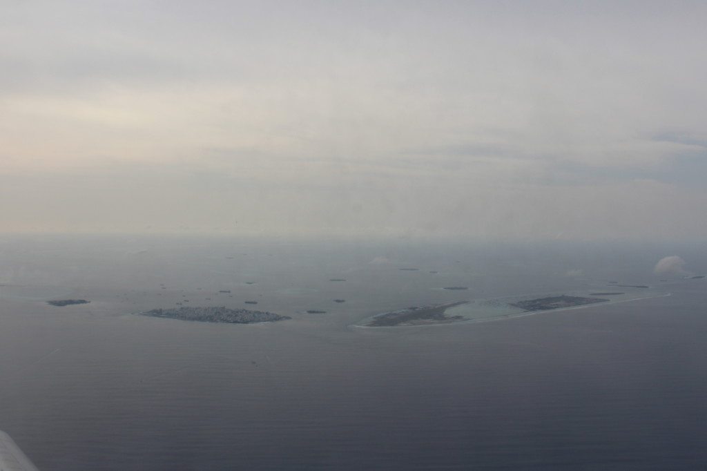 Malé and Hulhulé from the air. Malé is in the centre left, and Hulhulé's elongated shape for the airport runway is to the right. Further right again is the new suburb of Hulhumalé.