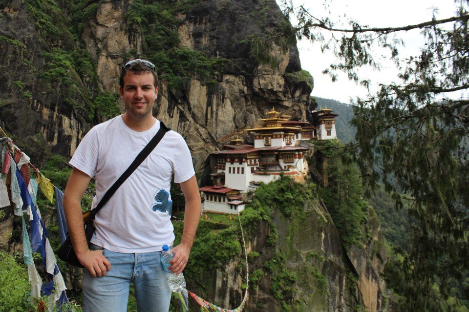 Me looking decidedly well-fed in front of Taktshang Goemba (Tiger's Nest Monastery)