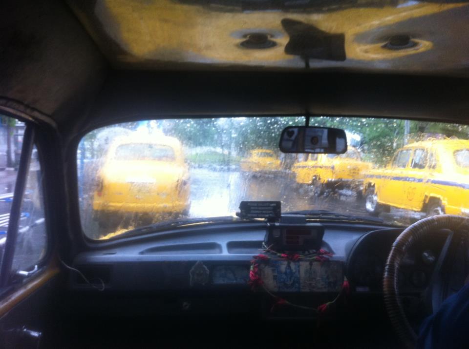 Iconic Kolkata scene; rain and yellow cabs.