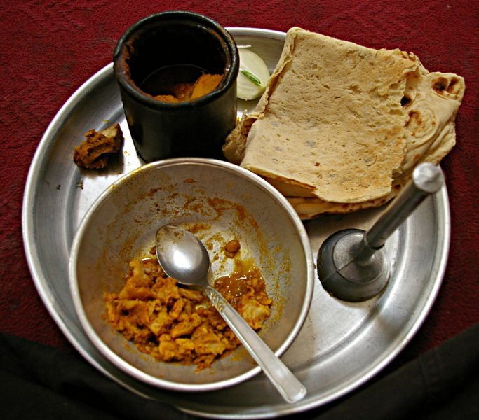 I didn't have a picture of the dizi (also known as abgoosht), so here is one I found online! The dish is cooked in the earthenware pot at the top of the picture. You drain the soup out of the pot mop it up with bread, then mash the vegetables and meat with the metal device on the right, then finish them off with any remaining soup and bread. Yum! (Image: Emesik)