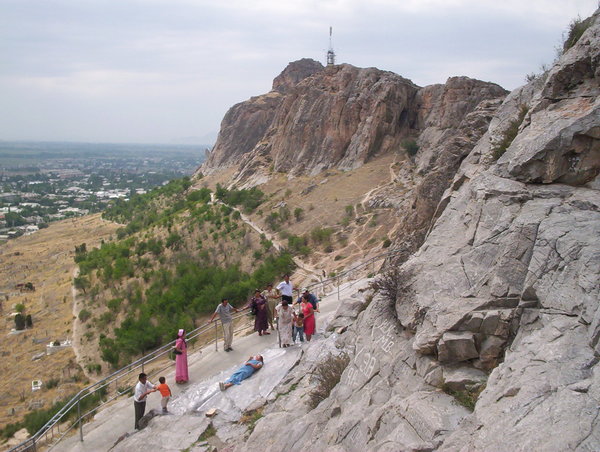 Women sliding along the rock at Solomon's Throne